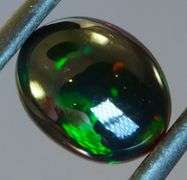 Block flashing 1.87ct black Opal cabochon