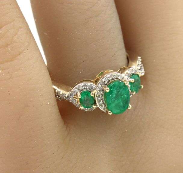 14kt Yellow gold 3 stone oval emerald and diamond halo ring