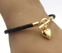 Black cord twisted bracelet with 14kt yellow gold heart shaped charm and toggle clasp
