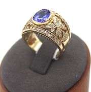14kt Yellow gold 3.45ct Oval Tanzanite in Intricate Diamond wide setting