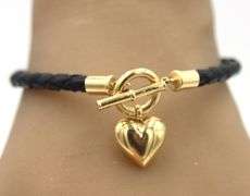 Black cord twisted bracelet with 14kt yellow gold heart shaped charm and toggle clasp