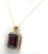 Emerald cut synthetic ruby and CZ halo frame pendant on chain in yellow gold