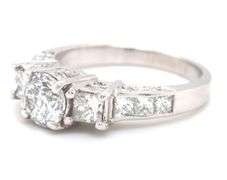 14kt White gold 0.90ct round brilliant cut with 1ctw RBC and PC side