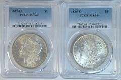 2 PCGS MS64+ 1885-O Morgan Silver Dollars. Beautiful pair