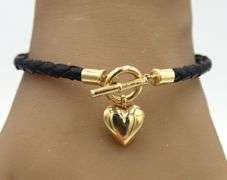 Black cord twisted bracelet with 14kt yellow gold heart shaped charm and toggle clasp