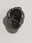 One 18kt black gold diamond and natural ruby skull pendent