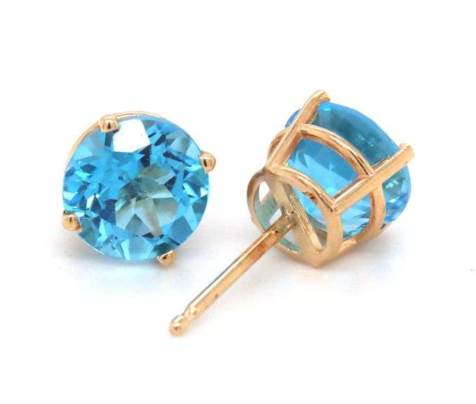 One pair of 14kt yellow gold round blue topaz stud earrings