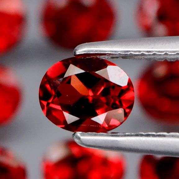 Lovely 5.51ct oval cut cherry red Garnet set