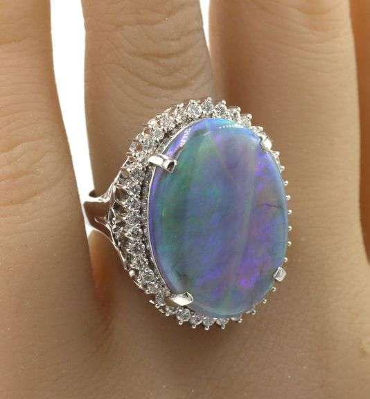 Platinum 10.92ct oval opal and 0.78ctw diamond halo ring
