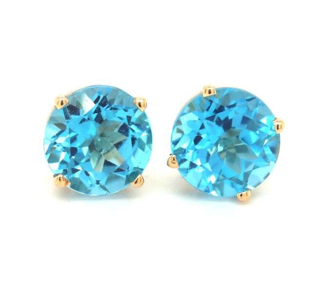 One pair of 14kt yellow gold round blue topaz stud earrings