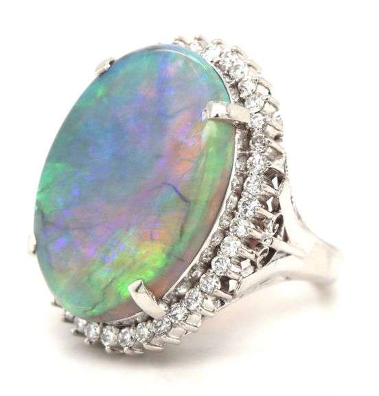 Platinum 10.92ct oval opal and 0.78ctw diamond halo ring