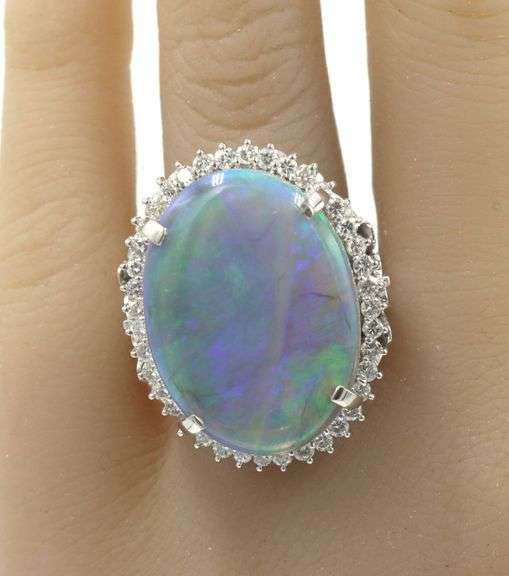 Platinum 10.92ct oval opal and 0.78ctw diamond halo ring