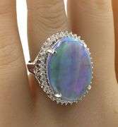 Platinum 10.92ct oval opal and 0.78ctw diamond halo ring
