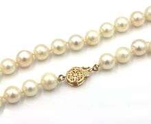White fresh water pearl strand necklace with gold clasp
