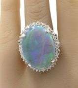Platinum 10.92ct oval opal and 0.78ctw diamond halo ring