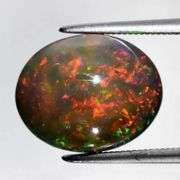 Smoldering color! 4.69ct Black Opal