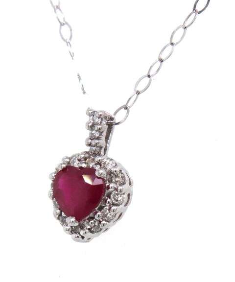 Set of ruby and diamond heart shaped pendant on chain, earrings and ring