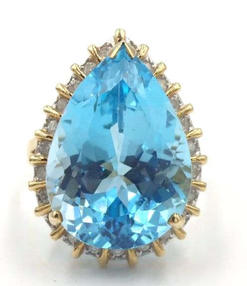 14kt Yellow gold 22ct pear blue topaz and 0.50ctw diamond halo ring