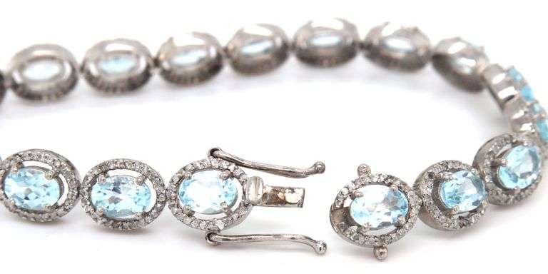 Sparkling 14.00CTW Oval Faceted Blue Topaz & 3.50CTW Diamond bracelet in 14K White Gold Over Sterlin