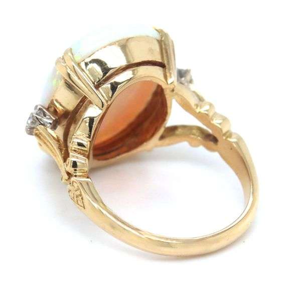 18kt Yellow gold 6.25ct oval opal and diamond ring