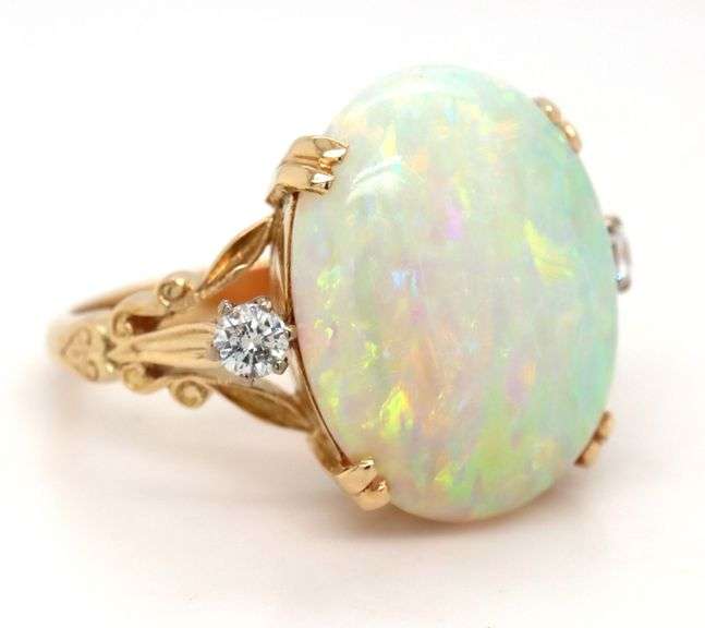 18kt Yellow gold 6.25ct oval opal and diamond ring