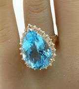 14kt Yellow gold 22ct pear blue topaz and 0.50ctw diamond halo ring
