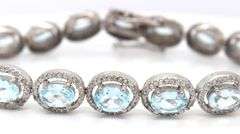 Sparkling 14.00CTW Oval Faceted Blue Topaz & 3.50CTW Diamond bracelet in 14K White Gold Over Sterlin