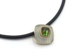 Cushion cut green tourmaline and rock crystal pendant on black leather cord