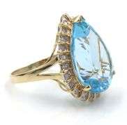 14kt Yellow gold 22ct pear blue topaz and 0.50ctw diamond halo ring