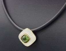 Cushion cut green tourmaline and rock crystal pendant on black leather cord