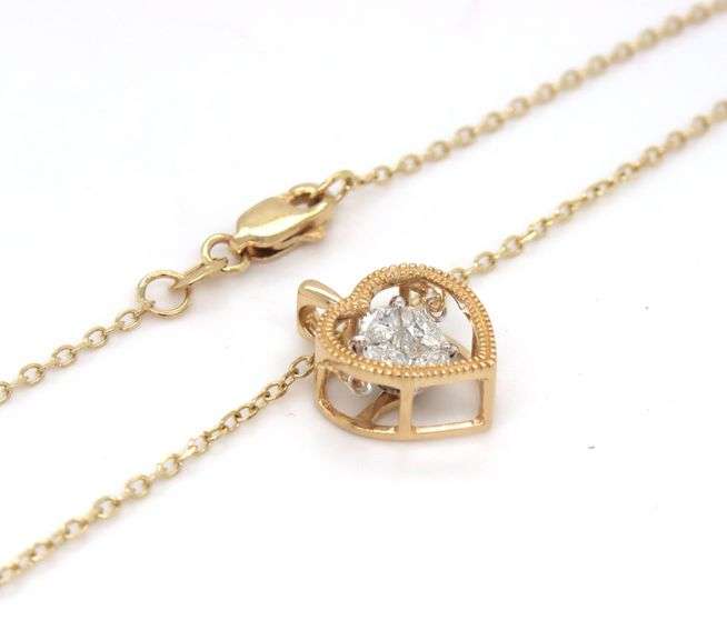 14kt Yellow gold 0.65ctw marquise and princess cut dancing diamond heart shaped pendant on chain