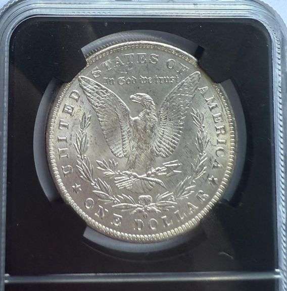 1884 O NGC MS 64 Morgan Dollar.With Original Bag Fragment