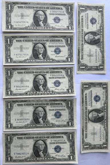 Seven 1935 E Unc $1 Silver Certificates.