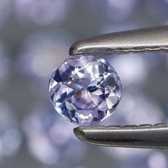Heavy flashing 3.46ct round cut Tanzanite set