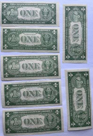 Seven 1935 E Unc $1 Silver Certificates.