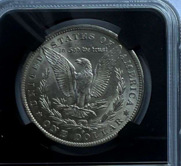 1884 O NGC BU Morgan Dollar.With Original Bag Fragment