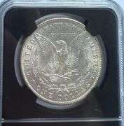 1884 O NGC MS 64 Morgan Dollar.With Original Bag Fragment