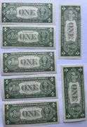 Seven 1935 E Unc $1 Silver Certificates.