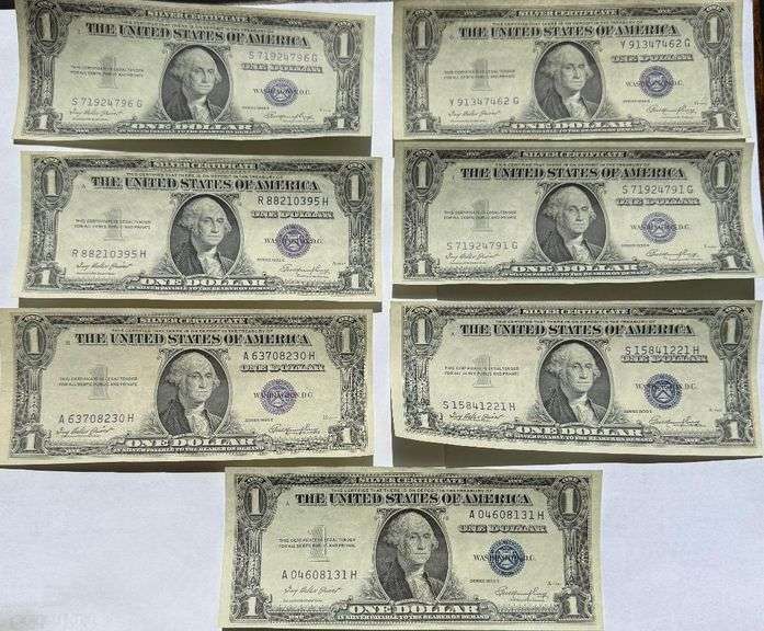 Seven 1935 E Unc $1 Silver Certificates.