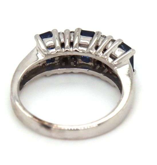 14kt White gold 1.10ctw emerald cut sapphire and diamond accent ring
