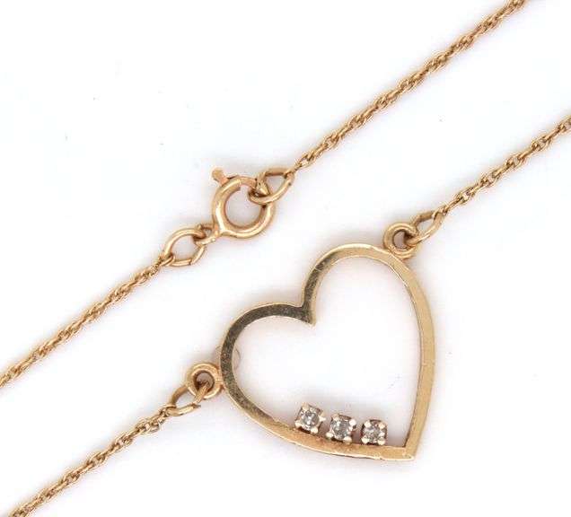 14kt Yellow gold heart shaped 3 stone diamond pendant on chain