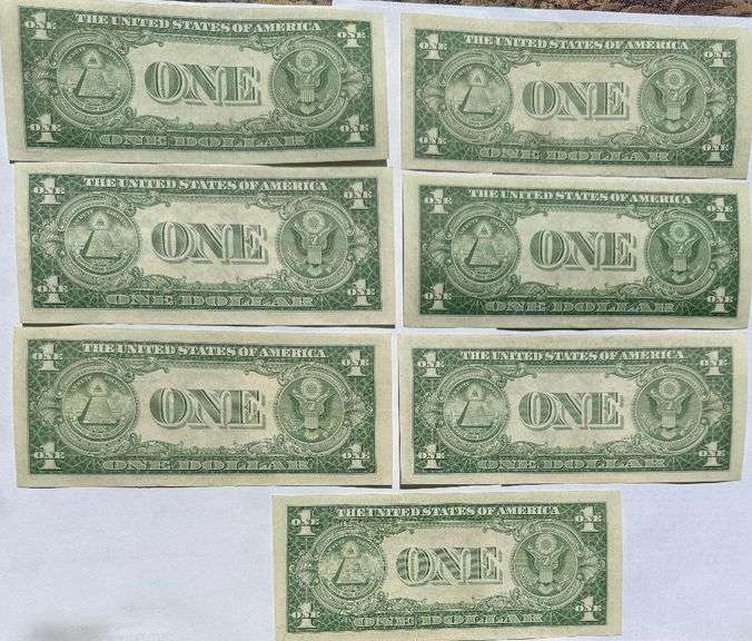 Seven 1935 E Unc $1 Silver Certificates.