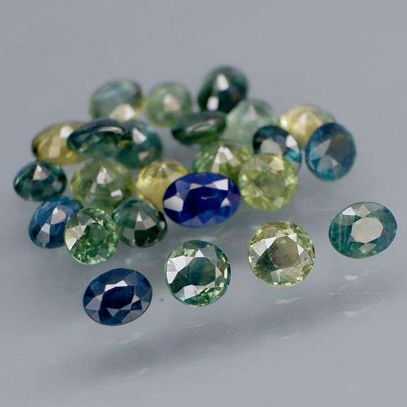 Heated only! 6.80ct mixed cut blue green Sapphire set