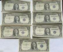 Seven 1935 E Unc $1 Silver Certificates.