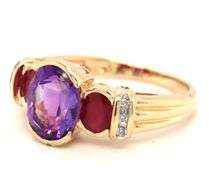14kt Yellow gold oval amethyst, ruby and diamond accent 3 stone ring