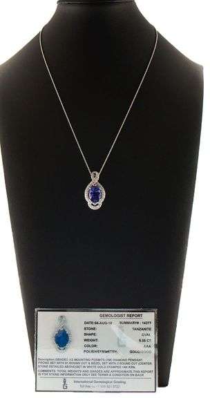 6.57ct Oval Tanzanite and 0.85ctw Diamond Swirl Framed Pendant Necklace in 14K