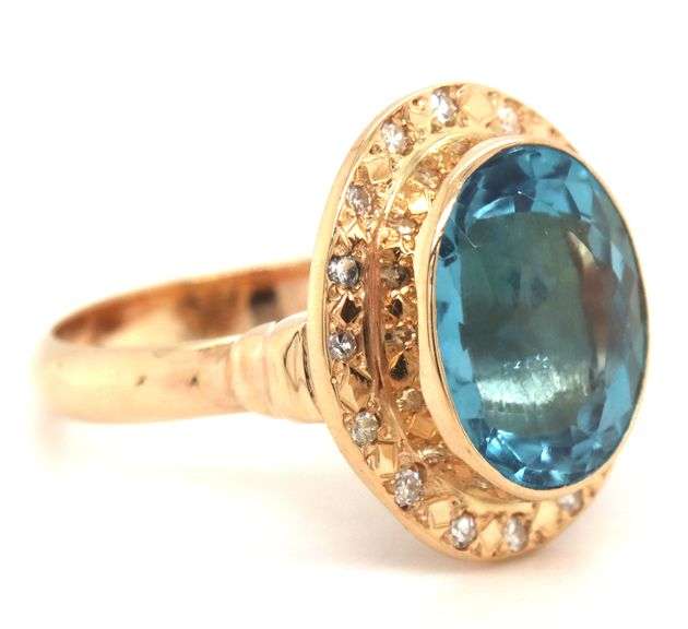 14kt Yellow gold bezel set oval blue topaz and diamond ring