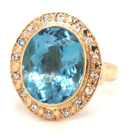 14kt Yellow gold bezel set oval blue topaz and diamond ring