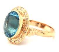 14kt Yellow gold bezel set oval blue topaz and diamond ring