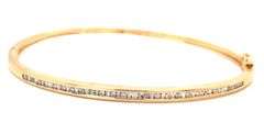 10kt Yellow gold 0.55ctw round brilliant cut and baguette bangle bracelet